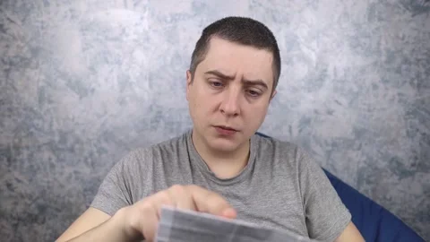 Man on a white background reads the instructions for medicines. Male looks at th Stock Footage 191020075