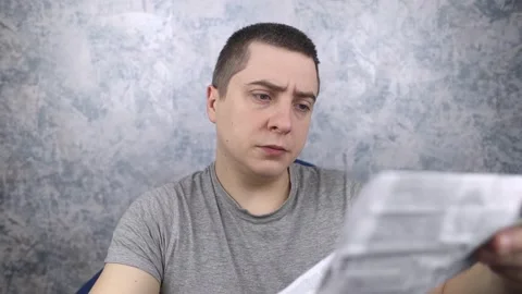 Man on a white background reads the instructions for medicines. Male looks at th Stock Footage 191020479