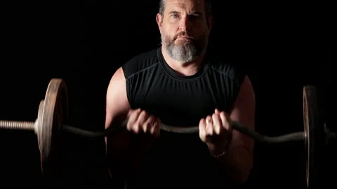 Man with white beard lifting heavy weights. Stock Footage 148879352