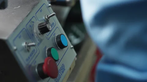 A man in a white coat and protective gloves works in a chemical laboratory with Stock Footage 271236571