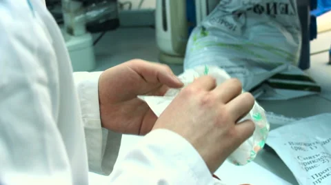 Man in a white coat examinate mango in the food control laboratory Stock Footage 59848313