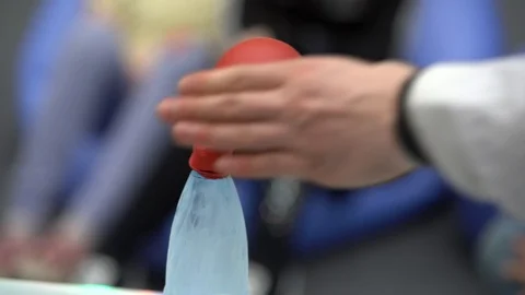 A man in a white coat puts on a plastic bottle filled  Stock Footage 105106467