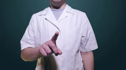 A man in a white coat stands in front of the screen and gestures. Video is Stock Footage 122158828