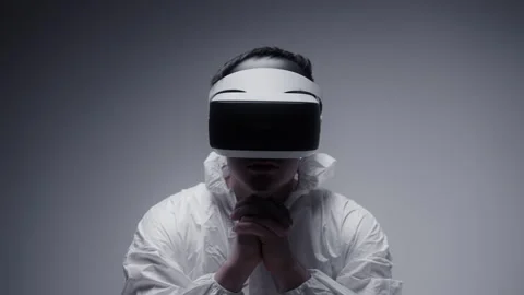 A Man in white coat with VR goggles against white background Stock-Footage 258544426