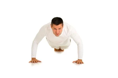 Man in white does push-ups Stock Photos