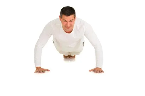 Man in white does push-ups Stock Photos