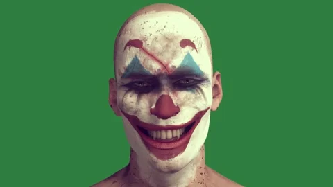 A man with white face and blue paint on his painted like joker red makeup Stock Footage 336858690