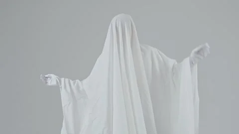 Man in a white ghost costume dances on a white background Stock Footage 287915512