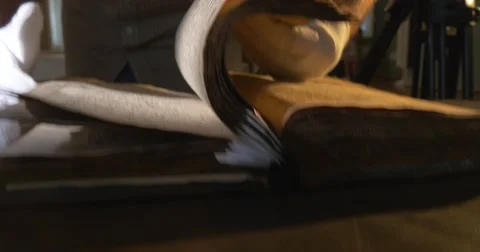 Man in White Gloves is Leafing Through The Old Book, Holding the Book, Stock Footage 52347414