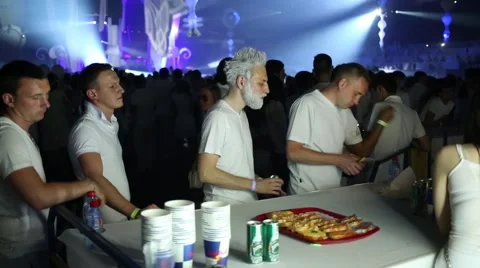 Man with white hair standing in queue at counter at Olympic Stadium Stock Footage 63661398