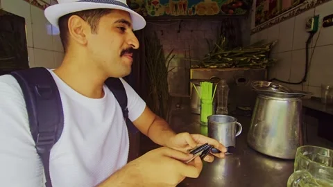 A man in a white hat is using a cell Stock Footage 292220137