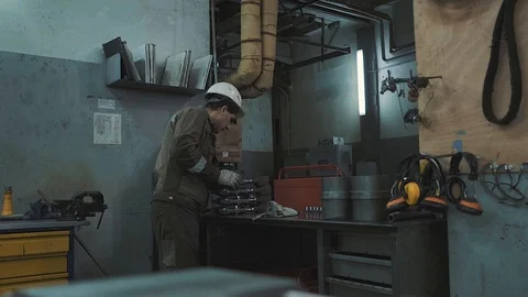 The man in the white helmet running on the machine. Plant. Factory. Stock Footage 126926790