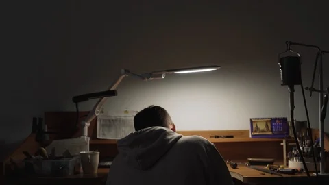 Man in a white jacket works in a workshop Stock Footage 105259419