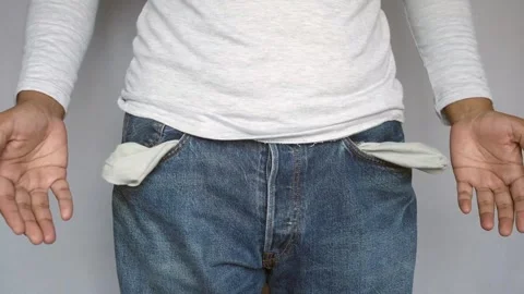 A man in a white long-sleeved t-shirt and blue jeans pulls out empty pocket.. Stock Footage 333030351