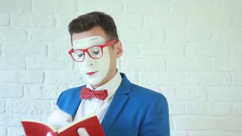 Man in a white mask reading a book Stock Footage 91541359