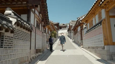 Man in white mask walking in Bukchon Han... | Stock Video | Pond5