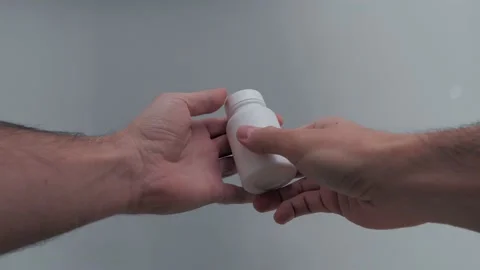 Man with white pill box in his hand takes pills and swallows Stock-Footage 131016714