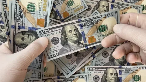 Man in white prints checks dollars, twists a hundred dollar bill, top view 스톡 동영상 128410655