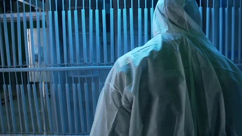 Man in white protective suit processes metal structure toxic chemical solution Stock Footage 117985375