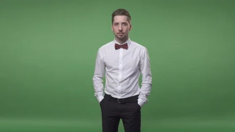 Man in a white shirt with a bow-tie and black pants Stock Footage