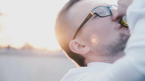 Man in a white shirt gets drunk Stock Footage 81543843