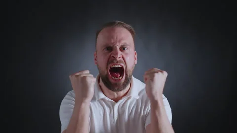 Man in white shirt, serious expression, dark background Vidéo 308073089