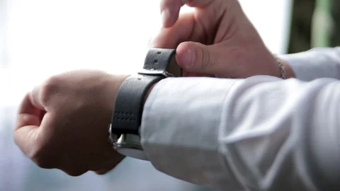 The man in the white shirt in the window wears watches. Stock Footage 89997689
