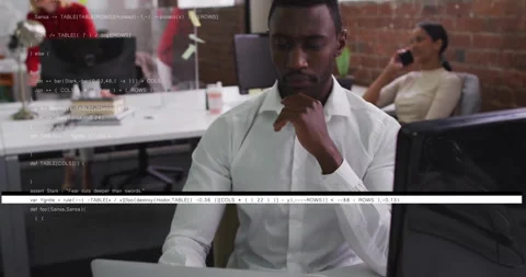 Man in white shirt working on computer with coding animation overlay Stock Footage 303537012