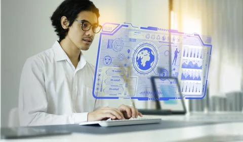 Man in white shirt working using computer keyboard with technology holograms. Foto stock