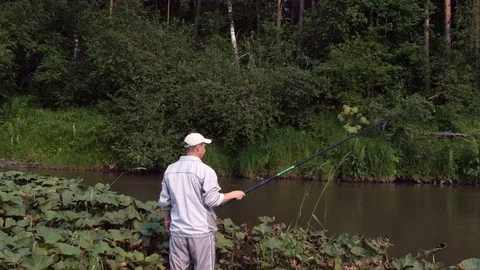 Man in a white suit is fishing Stock-Footage 80170853