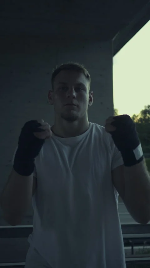 Man in White T-shirt Practicing Boxing Stance 库存影片 313957981