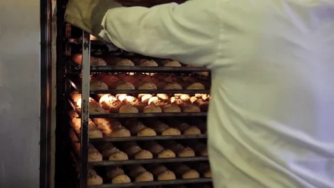 Man in white uniform take away baked cookies on bakery factory Video stock 76167003