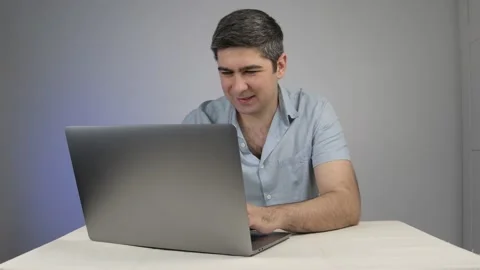 A man who is delighted with the correspondence with another person bites his Stock Footage 169443013