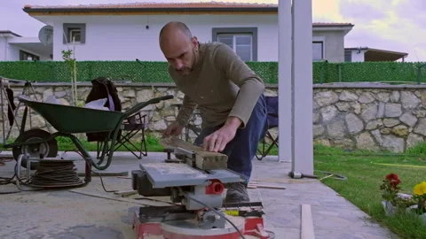 A man who is doing renovation work in his backyard. Stock Footage 236843218