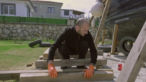 A man who is doing renovation work in his backyard. Stock Footage 236843421