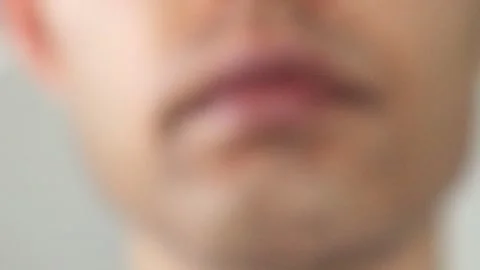 A man who has removed his mask and lost his beard through laser hair removal Video stock 326088632