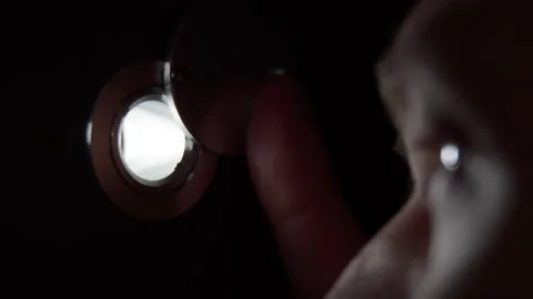 Man who looks through the peephole, close-up Stock Footage