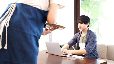 Man who orders coffee at a cafe Stock Footage 72558740