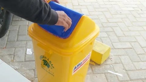 A man who throws rubbish in the trash can to protect the environment Stock Footage 265074445