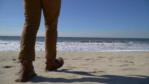 Man who is walking on the beach Stock Footage 82307369