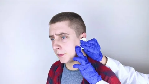 A man whose ear is bleeding. Vascular rupture, damage to the tympanic membrane,  Stock Footage 149169546