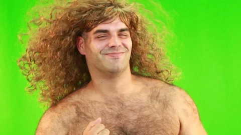 Man WIth A Wig Dancing And Having Fun Against The Green Background Stock Footage 97724280