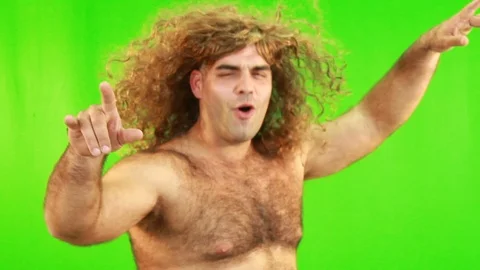 Man WIth A Wig Dancing And Having Fun Against The Green Background Stock Footage 97724615