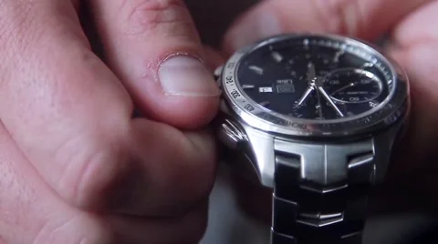 Man winding his watch Stock Footage 58873273