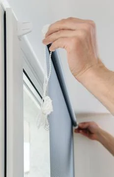Man with window blind. Stock Photos