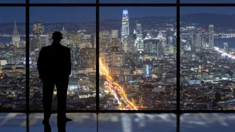 Man in window looking at city skyline at night Stock Illustration