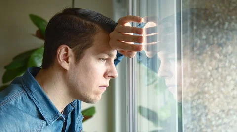 Man at window looking concerned Stock Footage 48012398