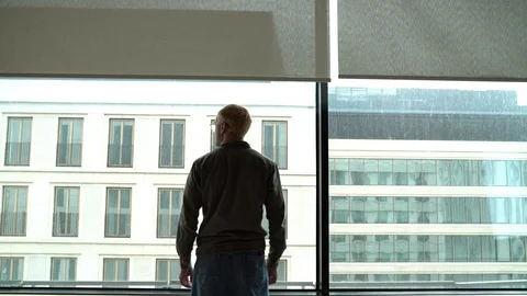 A man at the window in the office Stock Footage 129218617