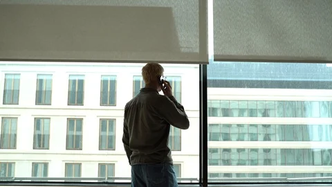 A man at the window in the office Stock Footage 129218627