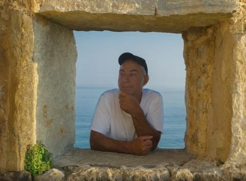 Man in window. Stock Photos